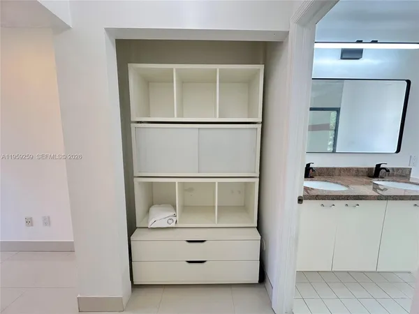 an empty room and chandelier fan