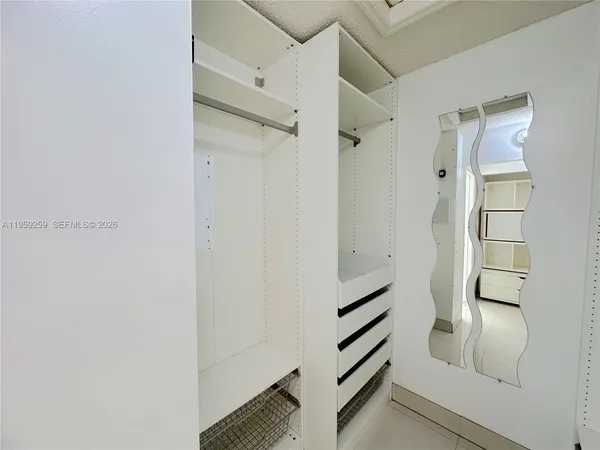 a bathroom with a granite countertop toilet a sink and a mirror