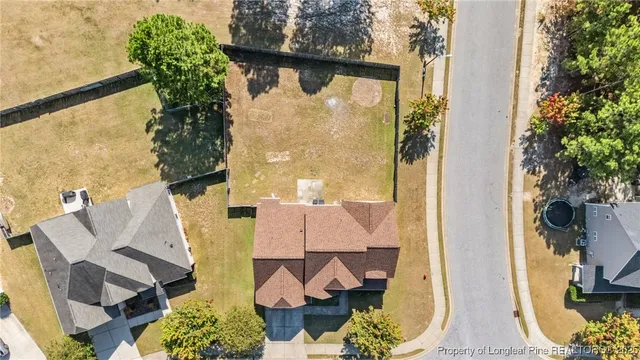 an aerial view of a house with swimming pool and glass doors