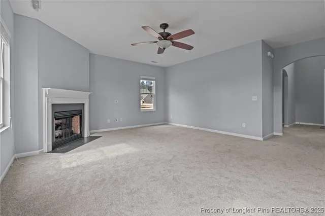 a view of a livingroom with a ceiling fan and window