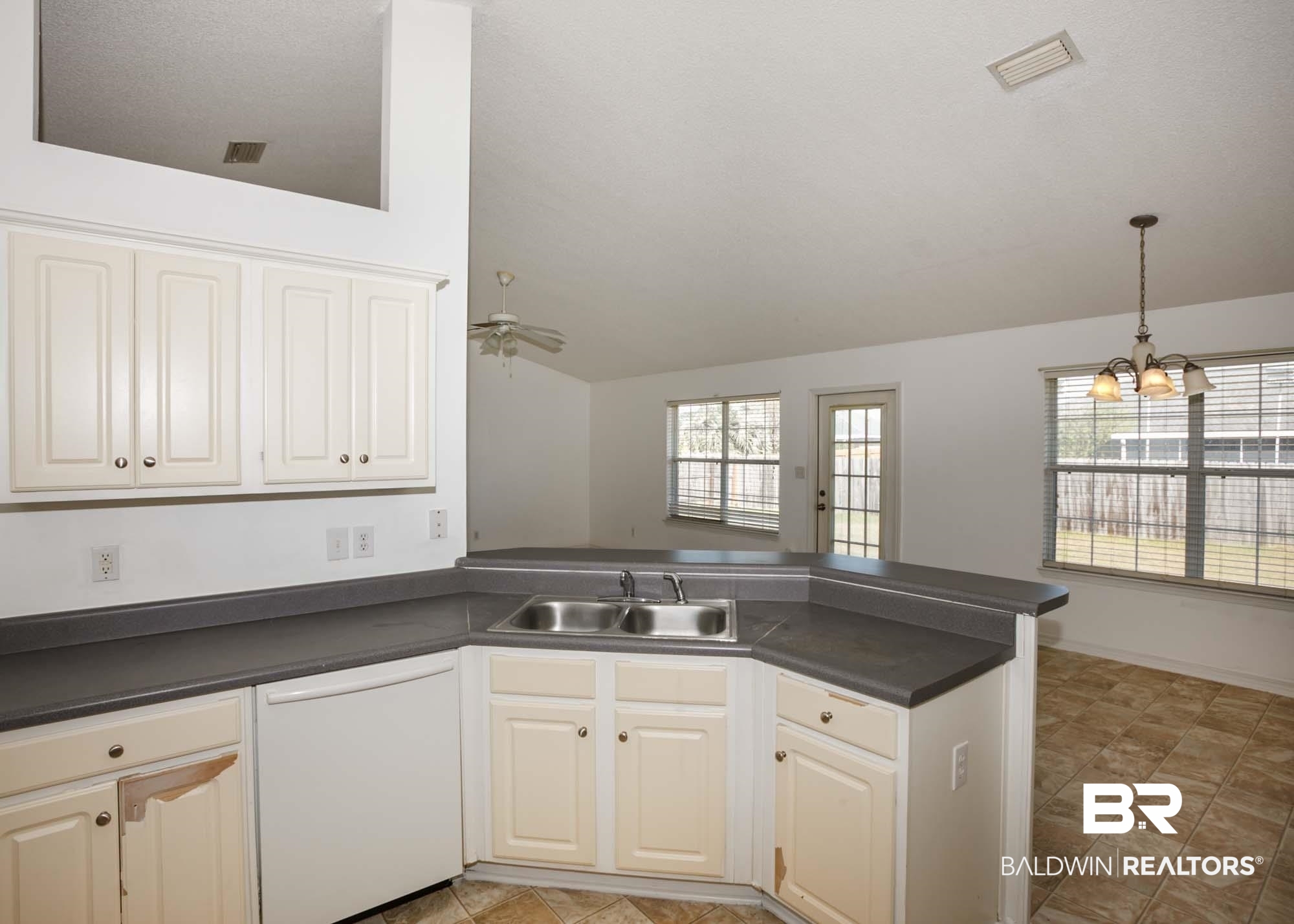 2530 Ashburn Lane Foley, AL 36535 - Photo 10 of 46 Kitchen with dishwasher, white cabinets, ceiling fan with notable chandelier, sink, and kitchen peninsula