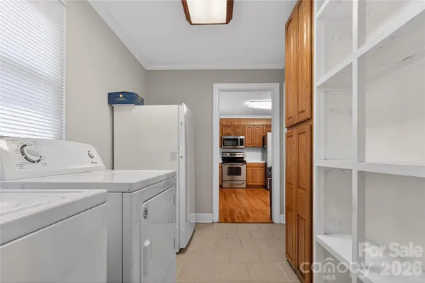 a kitchen with a refrigerator sink and cabinets