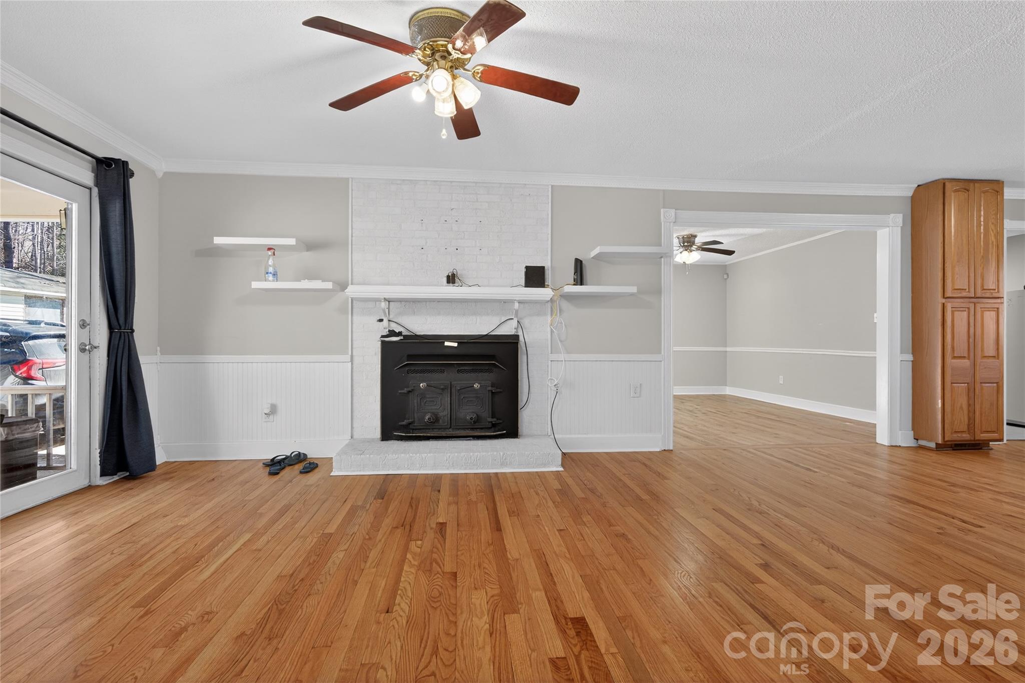 926 Mauney Road Stanley, NC 28164 - Photo 12 of 23 a view of empty room with wooden floor and fireplace