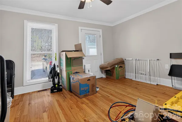 a bedroom with furniture and a flat screen tv