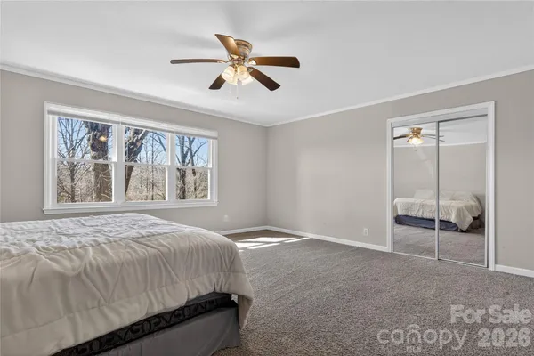 a bedroom with a large bed and a window