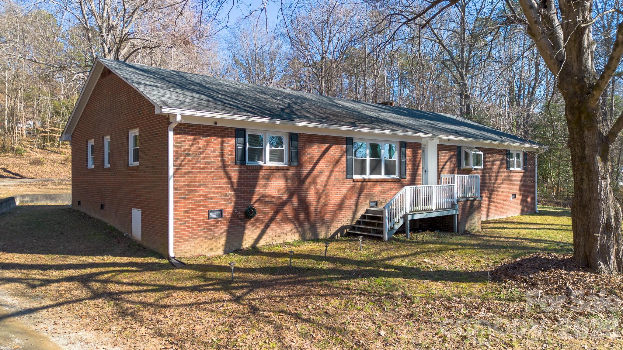 926 Mauney Road Stanley, NC 28164 - Photo 2 of 23 a view of a house with backyard and trees