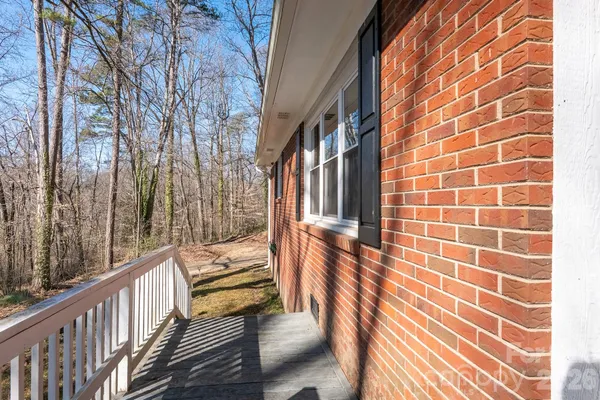 a view of a balcony with wooden floor and fence