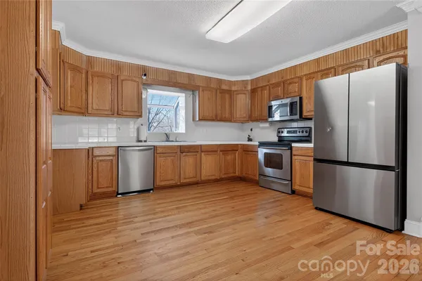 a kitchen with stainless steel appliances granite countertop a refrigerator sink and microwave