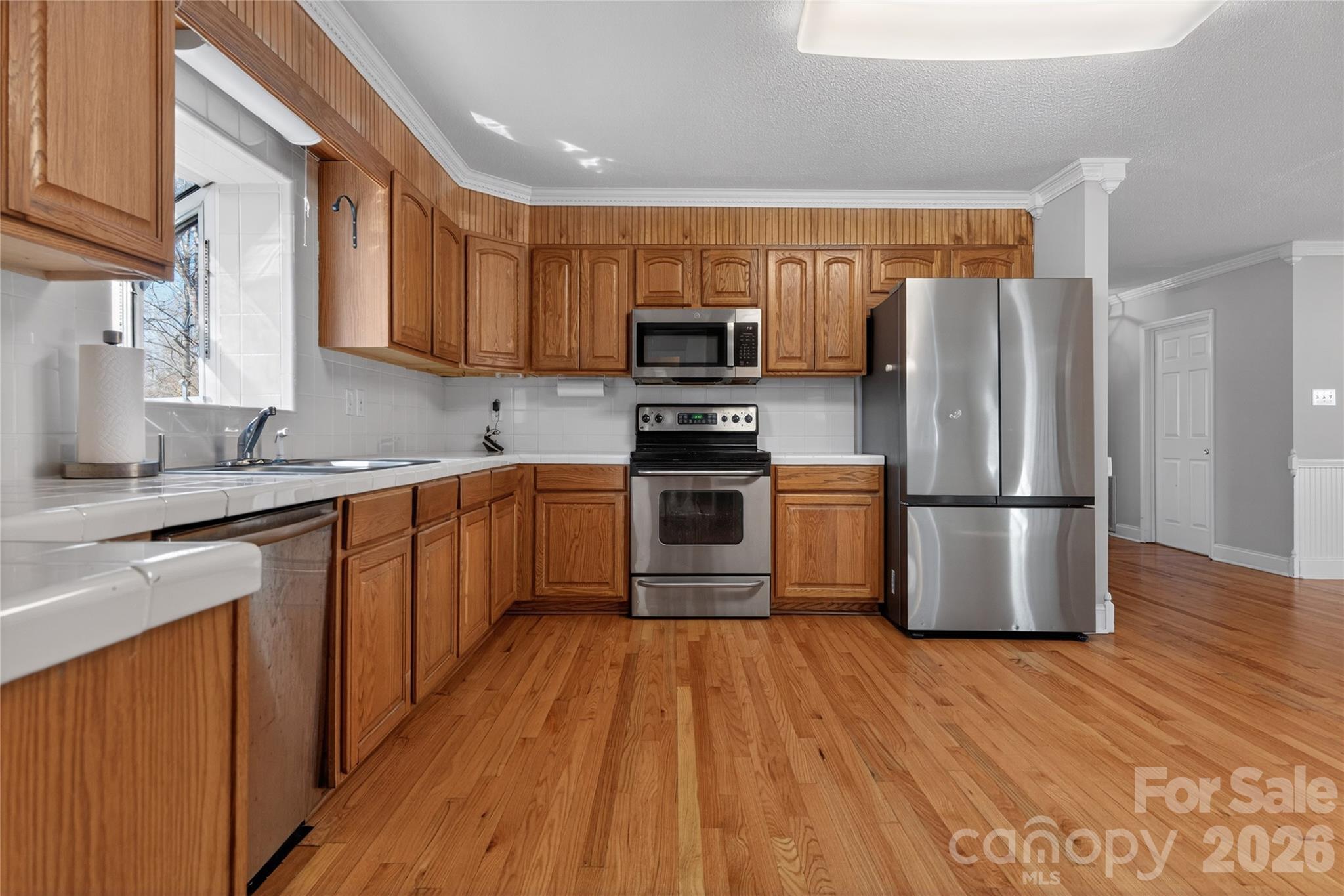 926 Mauney Road Stanley, NC 28164 - Photo 10 of 23 a kitchen with stainless steel appliances granite countertop a refrigerator stove and sink
