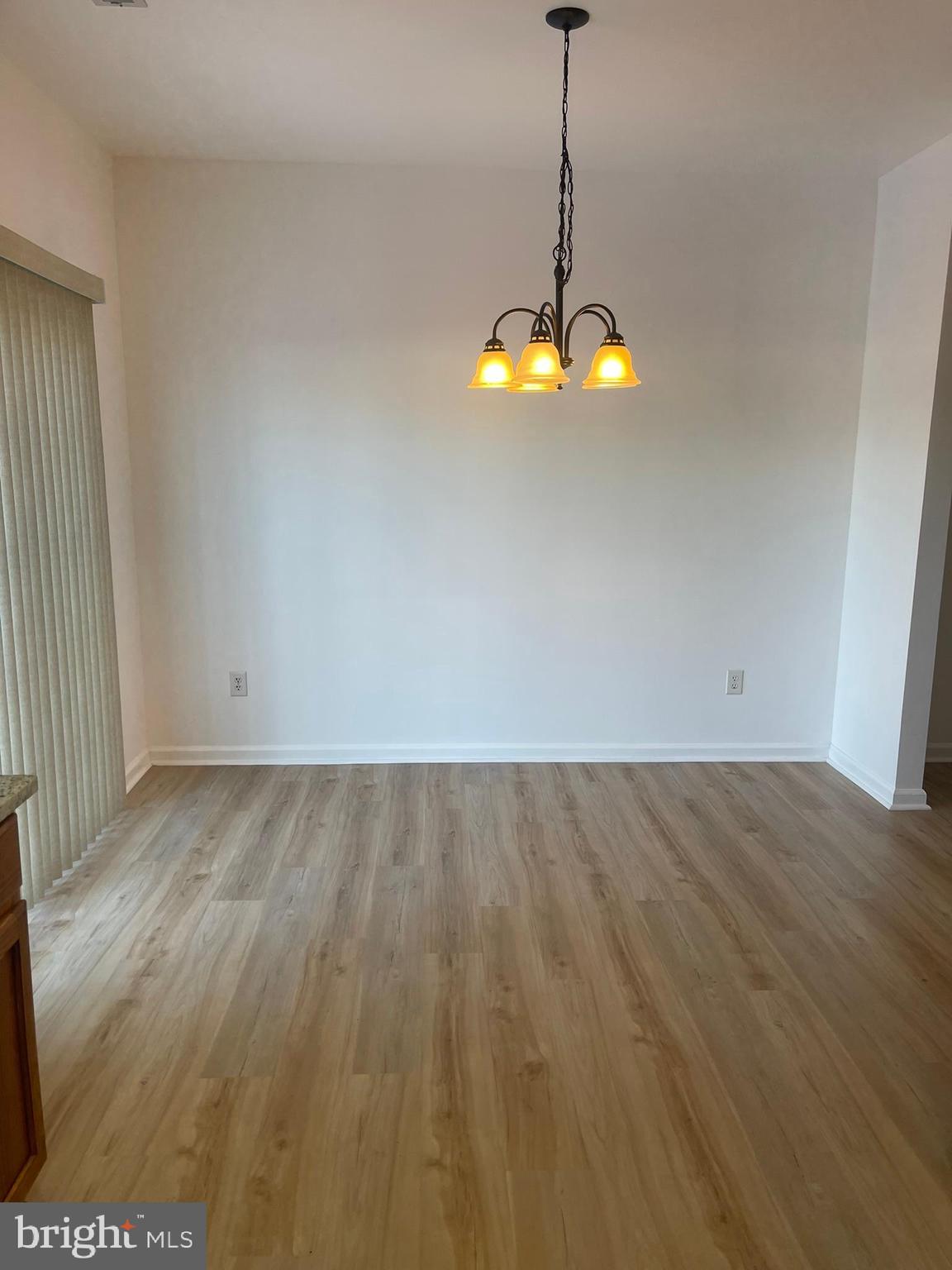 62 Springfield Circle Middletown, DE 19709 - Photo 13 of 37 a view of a room with a chandelier fan and wooden floor