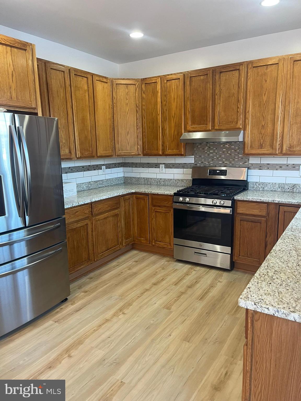 62 Springfield Circle Middletown, DE 19709 - Photo 17 of 37 a kitchen with stainless steel appliances granite countertop a stove a sink and a refrigerator