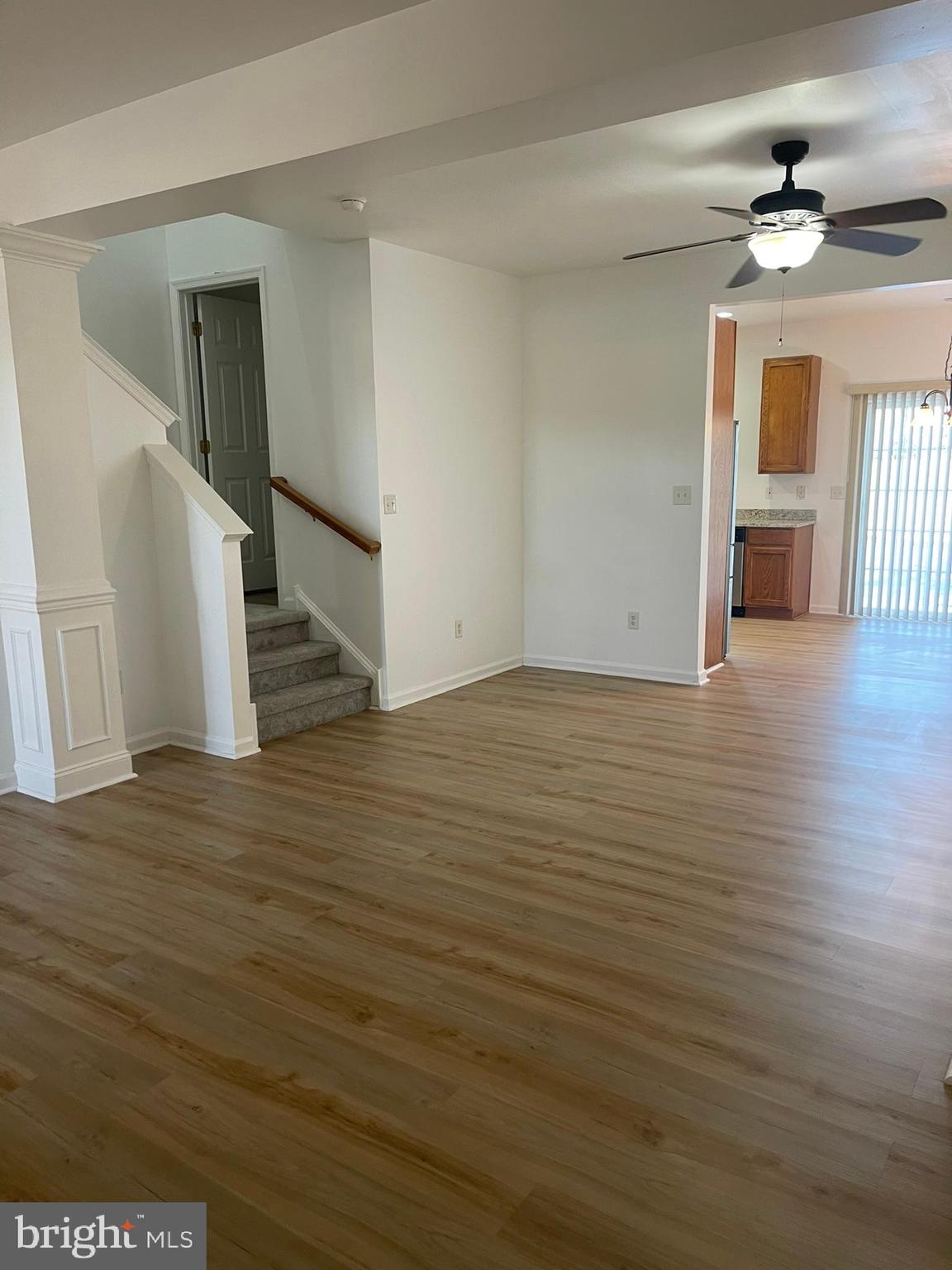 62 Springfield Circle Middletown, DE 19709 - Photo 9 of 37 a view of an empty room with wooden floor and a ceiling fan