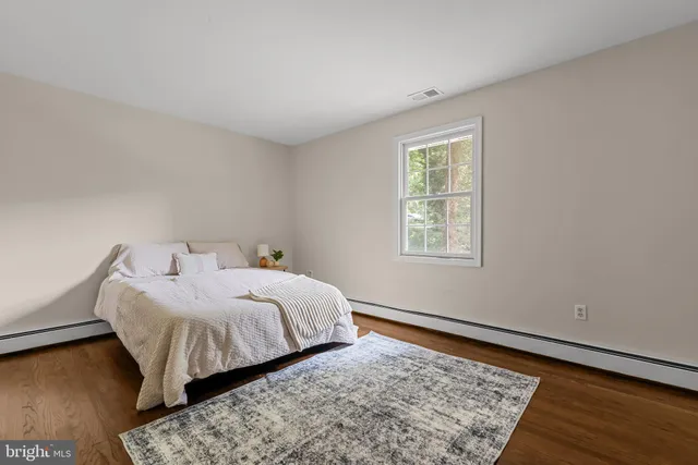 a bed room with a bed and a window