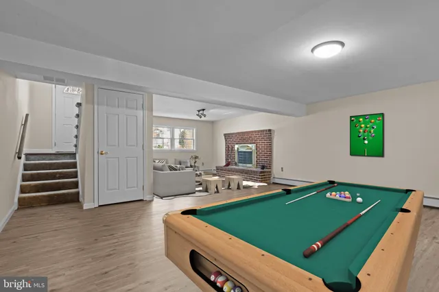 a room with pool table and windows