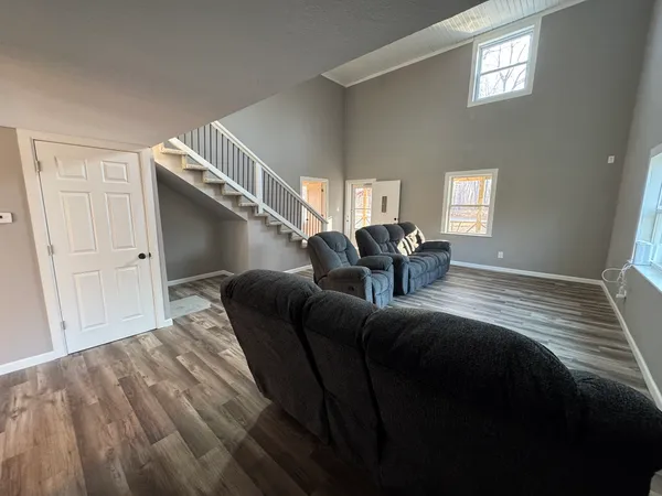 a kitchen with a refrigerator and wooden floor
