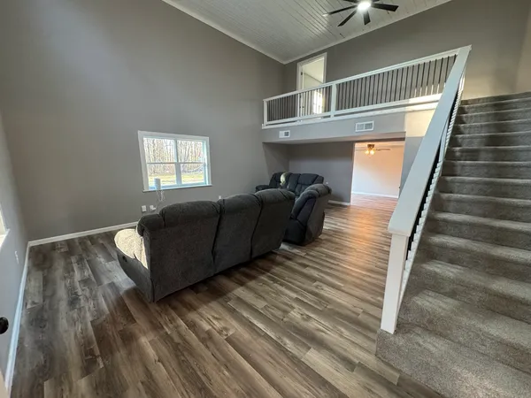 a kitchen with granite countertop white cabinets and a sink