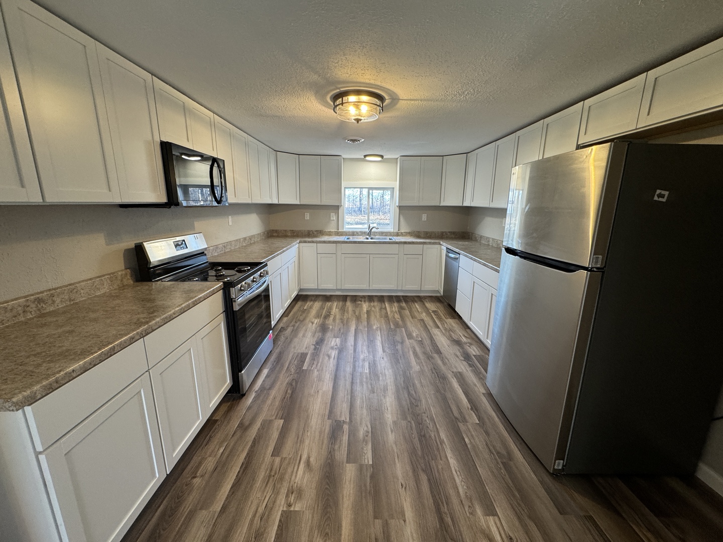 1981 Watercress Lane Flora, IL 62839 - Photo 7 of 76 a kitchen with a refrigerator and wooden floor