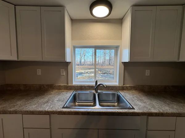 a stove top oven sitting inside of a kitchen