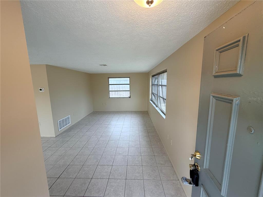 6330 Pennsylvania Avenue New Port Richey, FL 34653 - Photo 3 of 17 a view of an empty room with a window