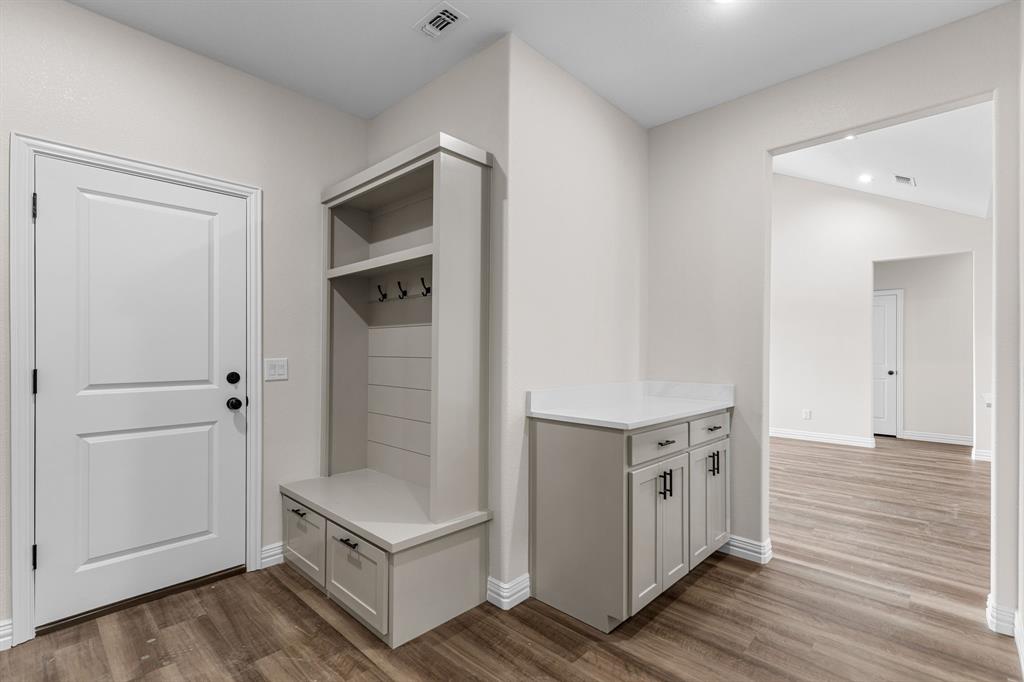4695 Sisk Road Wichita Falls, TX 76310 - Photo 13 of 32 Mudroom featuring hardwood / wood-style floors and vaulted ceiling