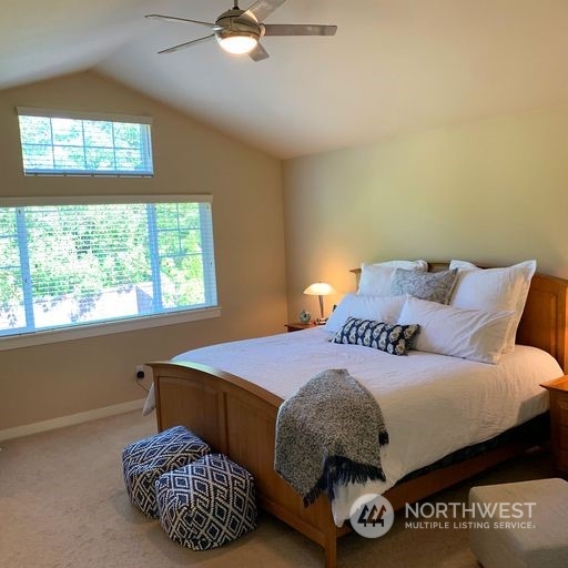 23029 35th Drive Southeast Bothell, WA 98021 - Photo 22 of 40 a bedroom with a bed two windows and a chandelier