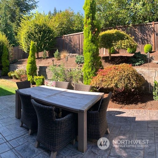 23029 35th Drive Southeast Bothell, WA 98021 - Photo 29 of 40 a view of a patio with table and chairs with wooden fence and plants