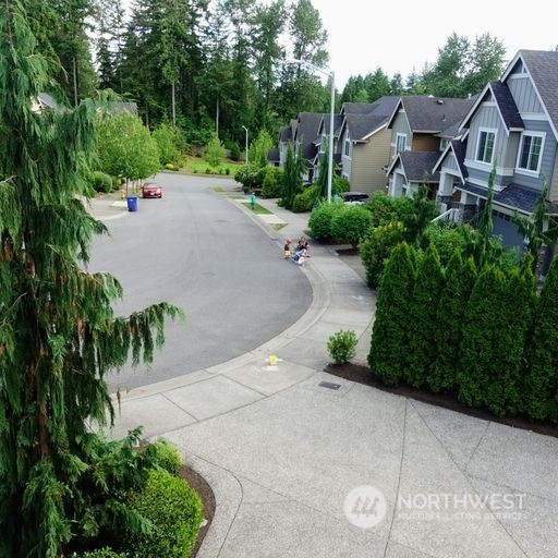 23029 35th Drive Southeast Bothell, WA 98021 - Photo 38 of 40 a view of a street with potted plants and large trees