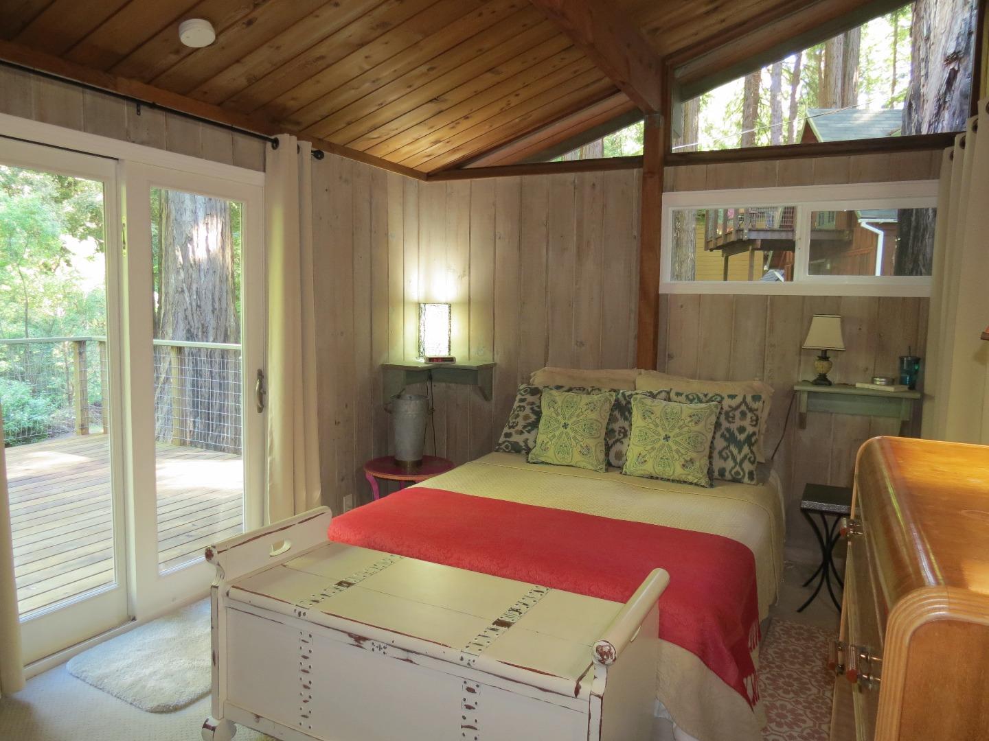 66 Wurr Road Loma Mar, CA 94021 - Photo 15 of 34 a bedroom with a bed and wooden floor