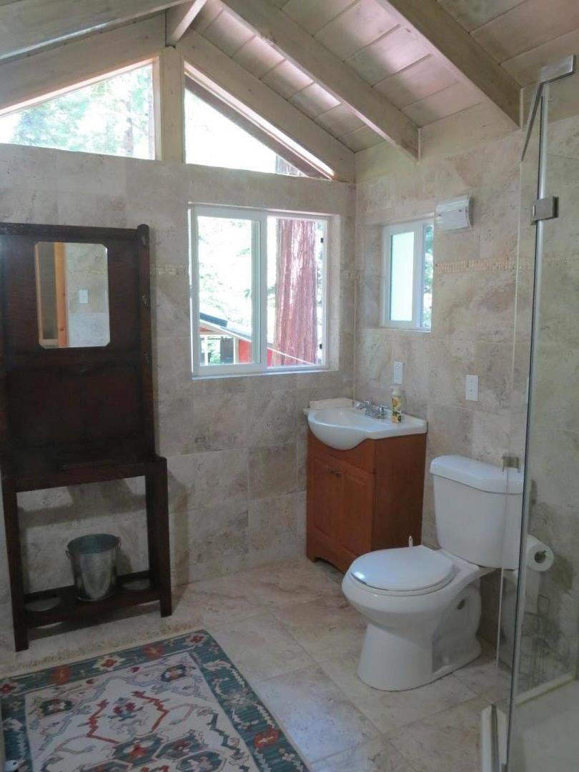 66 Wurr Road Loma Mar, CA 94021 - Photo 29 of 34 a bathroom with a toilet a sink and a mirror
