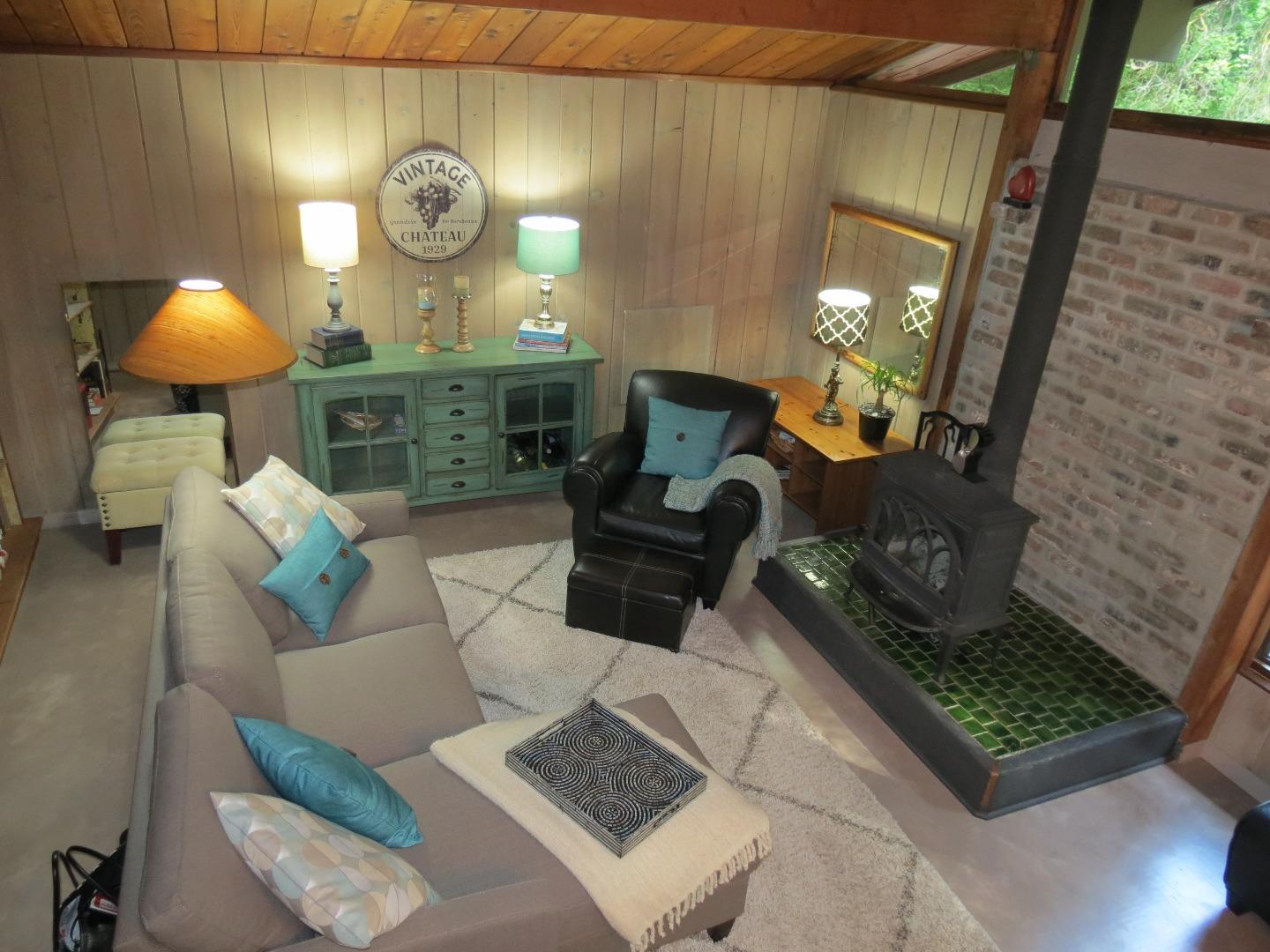 66 Wurr Road Loma Mar, CA 94021 - Photo 6 of 34 a living room with couches and a fireplace