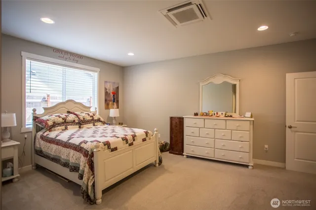 a bedroom with a bed and a dresser