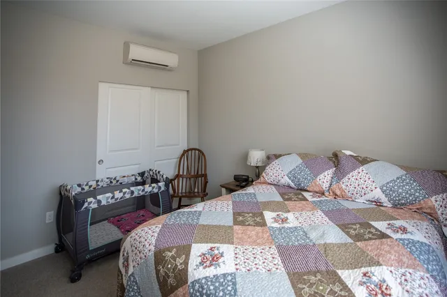 a bedroom with a bed and a lamp