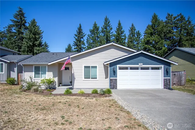 a view of a yard in front of a house with large trees