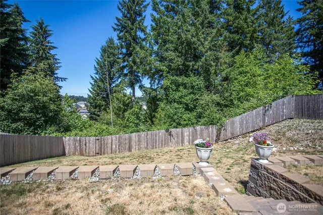 a view of a backyard with wooden fence