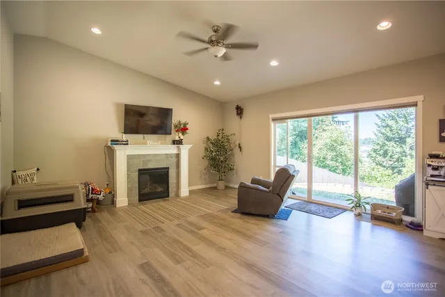 a living room with furniture fireplace and flat screen tv