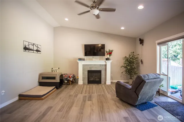 a living room with furniture a fireplace and a flat screen tv
