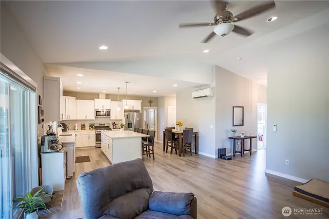 a living room with lots of furniture and kitchen view