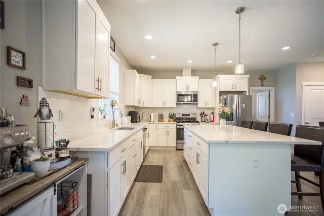a kitchen with white cabinets sink and white appliances