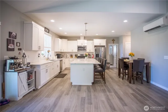 a large kitchen with a table and chairs