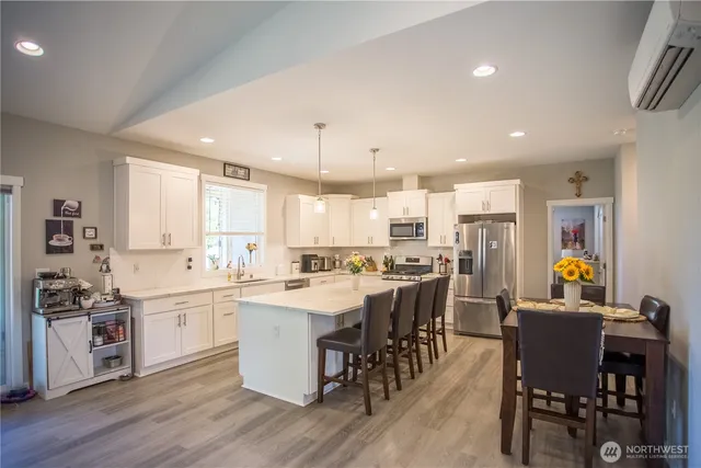 a large kitchen with a table and chairs