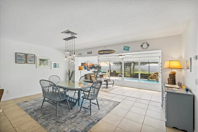 a view of a dining room with furniture wooden floor and chandelier
