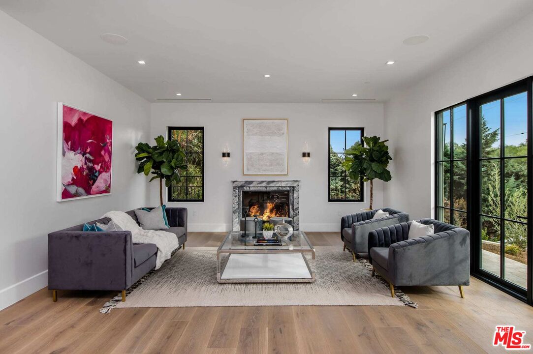 24961 Kit Carson Road Hidden Hills, CA 91302 - Photo 11 of 53 a living room with furniture and a fireplace