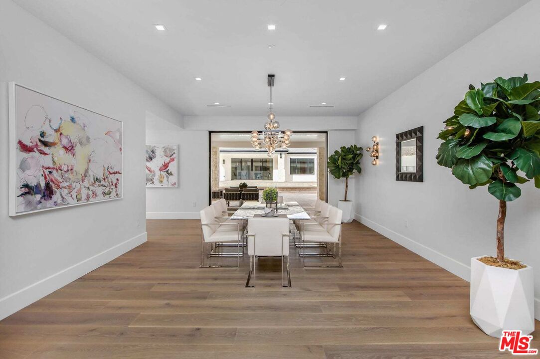 24961 Kit Carson Road Hidden Hills, CA 91302 - Photo 14 of 53 a living room with furniture a potted plant and a chandelier