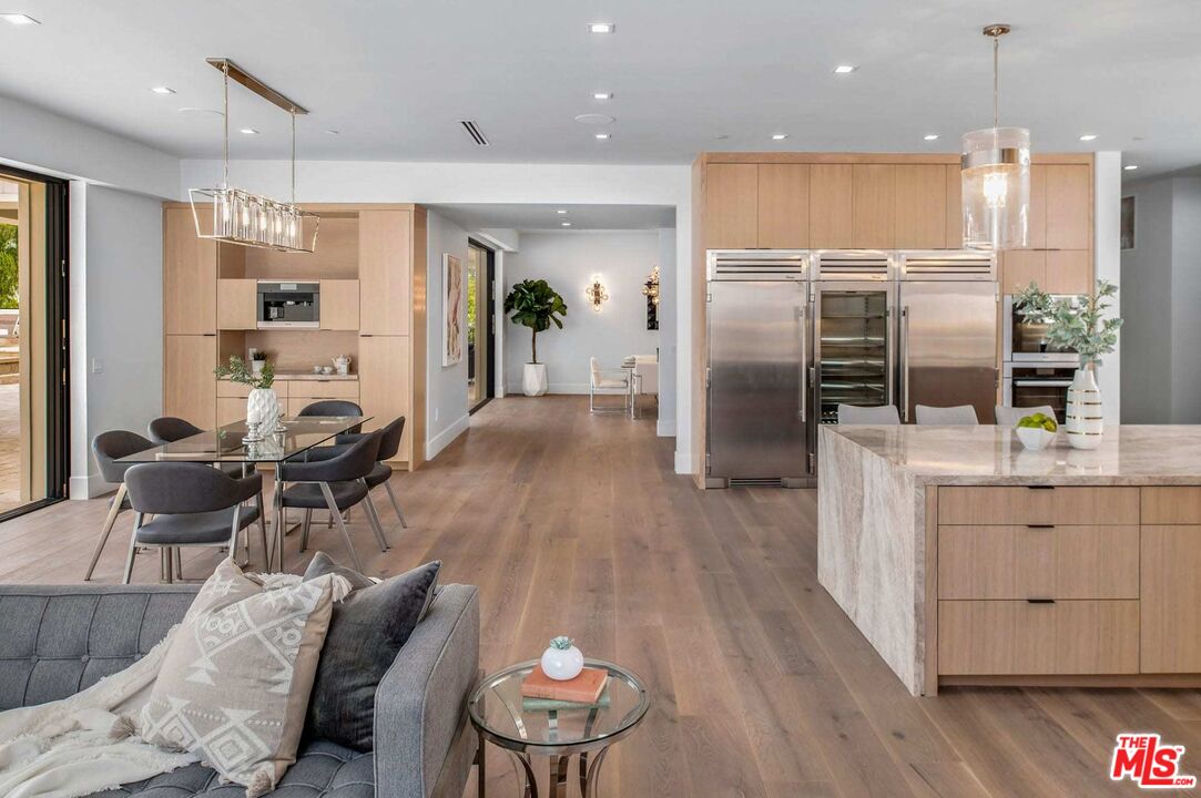 24961 Kit Carson Road Hidden Hills, CA 91302 - Photo 18 of 53 a kitchen with stainless steel appliances kitchen island granite countertop a refrigerator a stove and a wooden floors