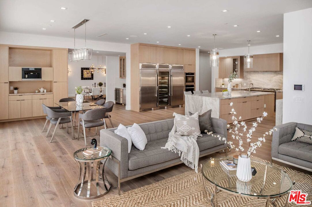 24961 Kit Carson Road Hidden Hills, CA 91302 - Photo 19 of 53 a living room with furniture and kitchen view