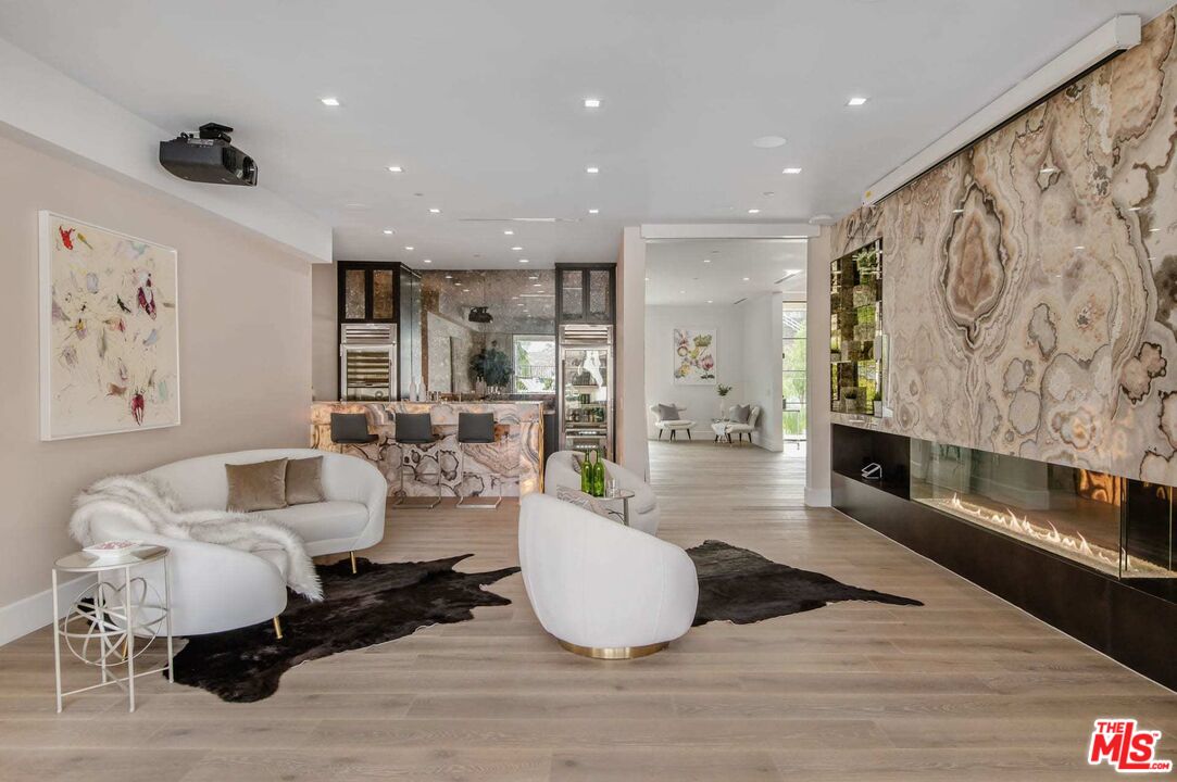 24961 Kit Carson Road Hidden Hills, CA 91302 - Photo 22 of 53 a living room with furniture and a fireplace