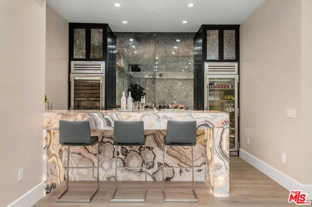 24961 Kit Carson Road Hidden Hills, CA 91302 - Photo 23 of 53 a view of a dining room with furniture window and wooden floor