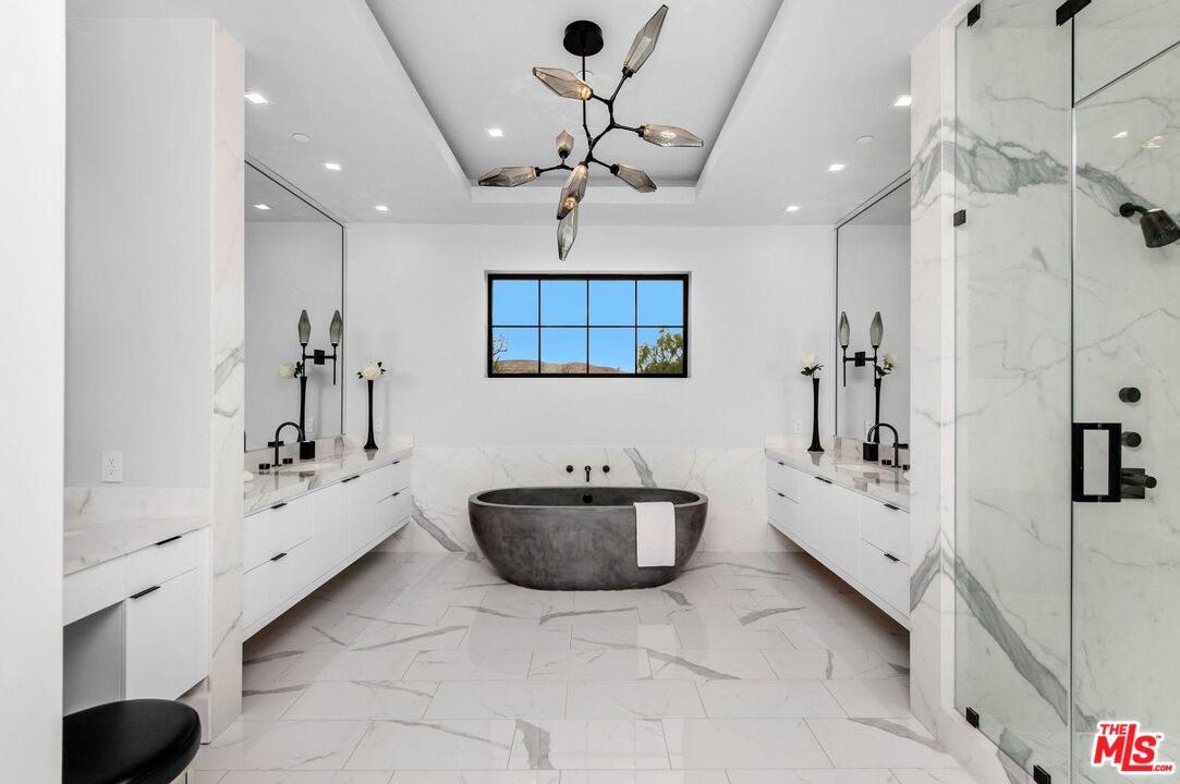 24961 Kit Carson Road Hidden Hills, CA 91302 - Photo 25 of 53 a spacious bathroom with a double vanity sink a mirror and shower