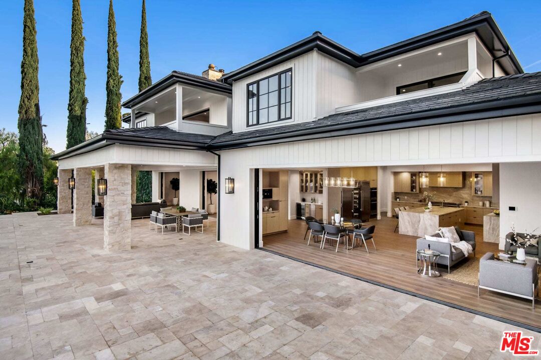 24961 Kit Carson Road Hidden Hills, CA 91302 - Photo 29 of 53 a view of a patio with table and chairs near a barbeque