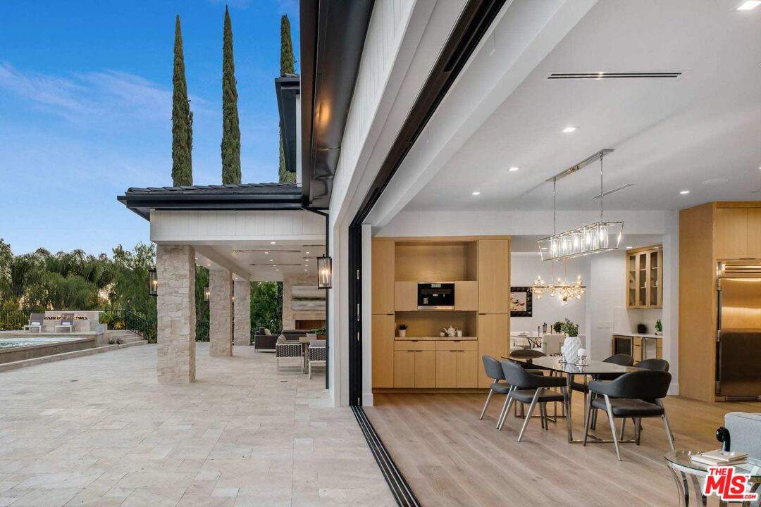 24961 Kit Carson Road Hidden Hills, CA 91302 - Photo 30 of 53 a kitchen with stainless steel appliances kitchen island granite countertop a refrigerator and a stove top oven